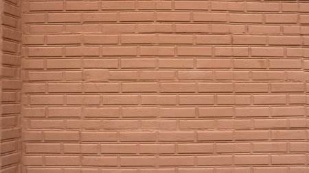 Brick masonry painted in a warm color with an aged texture as a background with an empty copy of the...