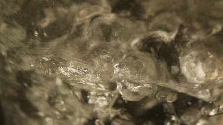 dark water in smooth motion, blurred background of seeing water with waves and eddies, frozen motion of boiling water in the process of boilingの写真素材