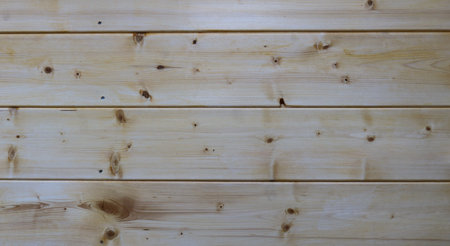 plank background of light knotty wood, wide planed boards as a texture of a wooden surface with...