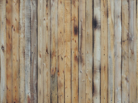 a fragment of a wooden fence made of narrow long boards with a natural texture and traces of aging wood and the impact of open air on the structure and coating of the woodの写真素材
