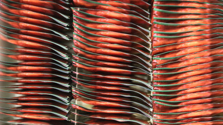 Red foil packets with darkened corners, tightly arranged with the narrow ends up, creating an abstract textured, colored, volumetric, corrugated background, full frameの写真素材