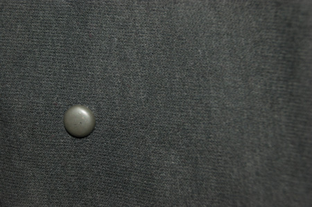 Grey textile with metal stud close-upの写真素材