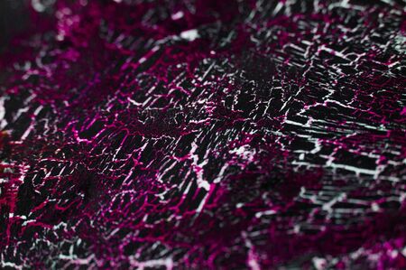 Craquelured black and pink color paper texture close-upの写真素材
