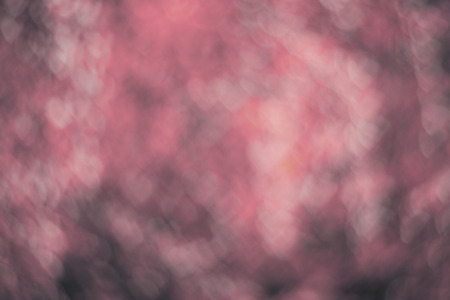 Texture made of defocused pink background with with heart shaped bokeh toned imageの写真素材