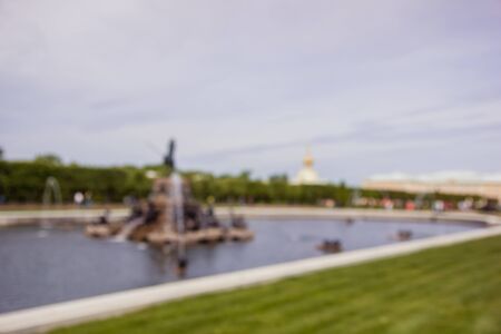 Blurred image of Peterhof, Russia. Tourists walking in the parkの写真素材
