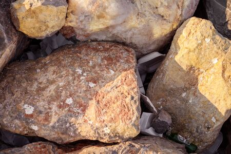 IZMIR, TURKEY, JULY 29, 2019: garbage in stones on sea coast. Concept of combating environmental problems pollution. Sunset time, close-up, shallow depth of fieldのeditorial素材