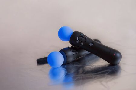 SAINT-PETERSBURG â RUSSIA - JULY 12 2019: Two Playstation Move motion controller for Sony PlayStation console / Virtual Reality (VR) games on light background. Shallow depth of field, place for textのeditorial素材
