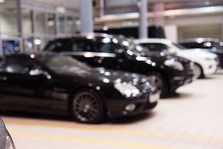 Defocused image. Many cars in car salon. Shallow depth of field