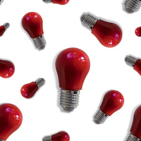 Seamless texture made by small red light bulbs top view flat lay on white background. Concept of idea, thought arising.の写真素材
