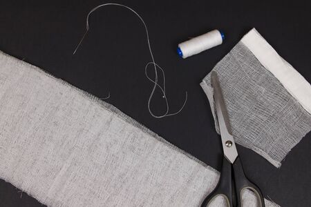 Do-it-yourself medical mask flat lay. Sew your own mask using gauze, scissors and needle with...