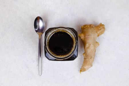 Buckwheat honey, ginger and spoon flat lay. Natural medicine, healthy food, ethnoscience, strengthening immunity. Horizontal picture with copy space, close-up, shallow depth of field.の写真素材