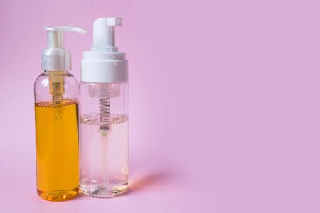 Skin care cosmetics. Facial wash gels on pink background with place for text. の写真素材