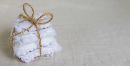 Reusable cotton discs set for face or makeup removal tied with twine flat lay. Eco-friendly lifestyle banner, zero waste concept.の写真素材