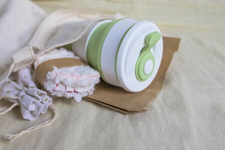 Eco-friendly shopping. Shopper bag with collapsible silicone mug, mesh bag and reusable cotton discs set for face or makeup removal tied with twine. Zero waste conceptの写真素材