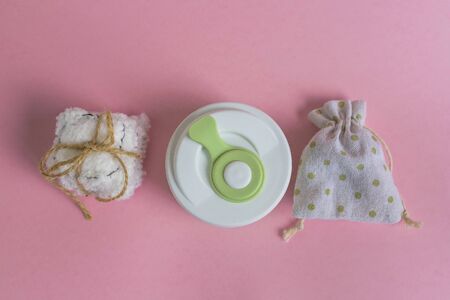 Collapsible silicone mug, mesh bag and reusable cotton discs set for face or makeup removal tied with twine. Zero waste concept top view on pink background. Eco-friendly lifestyleの写真素材