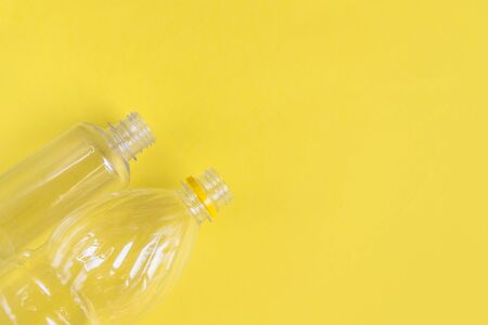 Plastic bottles top view on yellow background with copy space. Stop plastic concept. Say no to plastic. Garbage sorting. Recycling garbage. Single-use plastic objects. Ecological pollution.の写真素材