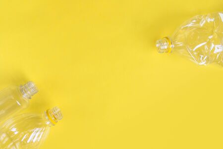 Plastic bottles top view on yellow background with copy space. Stop plastic concept. Say no to...