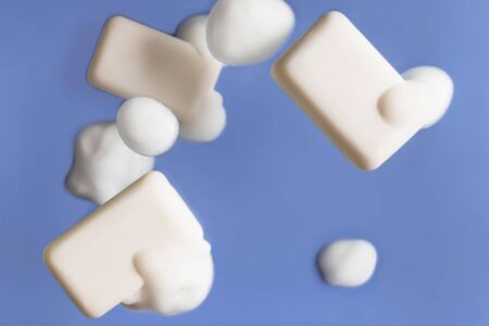 Soap and foam falling. Picture with selective focus on blue background. Levitation of objectsの写真素材