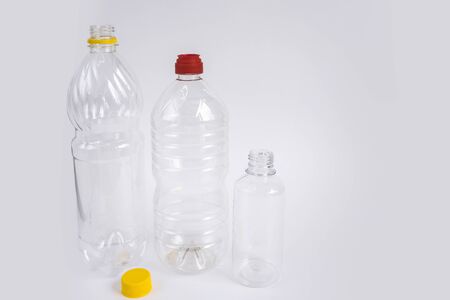 Plastic waste. Bottles and containers. Recycling garbage on white background with copy space. Stop plastic concept. No to plastic. Garbage sorting. Single-use plastic objects. Ecological pollution.の写真素材