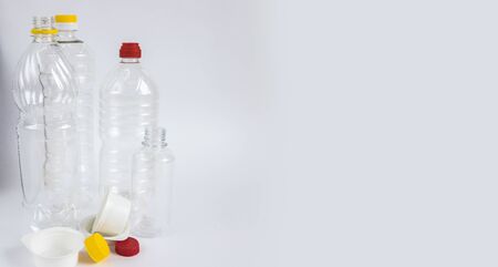 Plastic waste. Bottles and containers. Recycling garbage on white background with copy space. Stop plastic concept. Copy space. Garbage sorting. Single-use plastic objects. Ecological pollution.の写真素材
