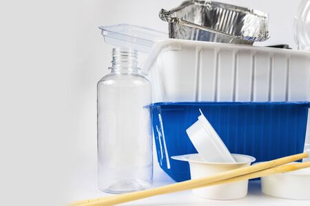 Plastic waste bottles and containers, chopsticks and aluminum container. Recycling garbage on white background Stop plastic concept. Garbage sorting. Single-use plastic objects. Ecological pollution.の写真素材