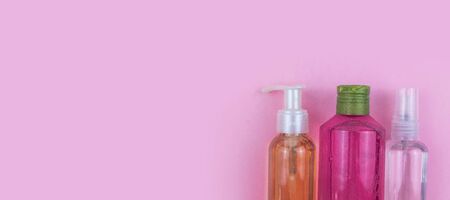 Skin care cosmetics. Facial and body wash gel and spray on pink background with copy space. Selective focus bannerの写真素材