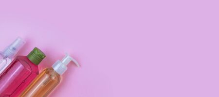 Skin care cosmetics. Facial and body wash gel and spray on pink background with copy space. Selective focus bannerの写真素材