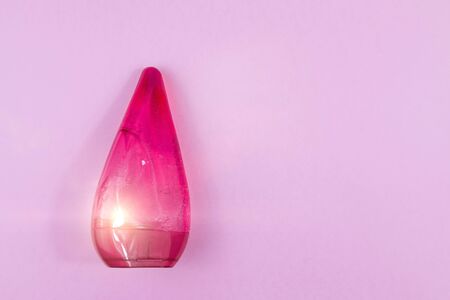 Skin care cosmetics. Facial or body wash gel or Body lotion in red bottle on pink background with place for text. Selective focusの写真素材
