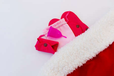 Menstrual cup and Reusable Menstrual Pad as a gift for the new year, Christmas, flat lay. Zero waste concept. Caring for the environment. Women Health. Picture with copy spaceの写真素材