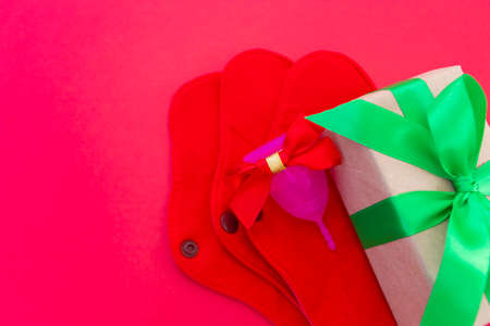 Menstrual cup and Reusable Menstrual Pad as a gift for the new year, Christmas, flat lay. Zero waste concept. Caring for the environment. Women Health. Picture with copy spaceの写真素材