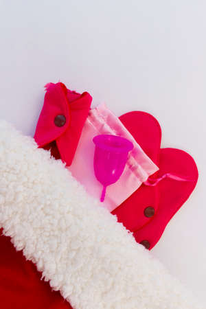 Menstrual cup and Reusable Menstrual Pad as a gift for the new year, Christmas, flat lay. Zero waste concept. Caring for the environment. Women Health. Picture with copy spaceの写真素材