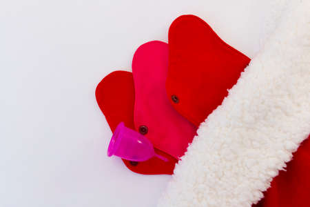 Menstrual cup and Reusable Menstrual Pad as a gift for the new year, Christmas, flat lay. Zero waste concept. Caring for the environment. Women Health. Picture with copy spaceの写真素材