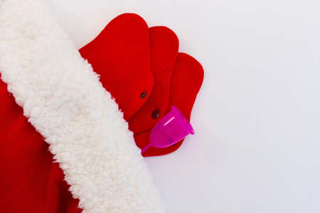 Menstrual cup and Reusable Menstrual Pad as a gift for the new year, Christmas, flat lay. Zero waste concept. Caring for the environment. Women Health. Picture with copy spaceの写真素材