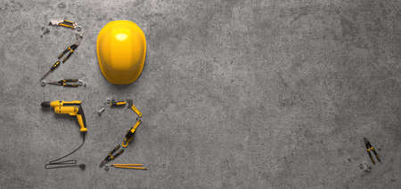 "2022" made from a set of construction tools and a protective helmet on a gray background. Creative 2022 New Year calendar or felicitation template for building and engineering companies. 3D render.の写真素材