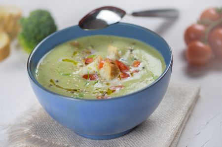 bowl of broccoli cream soup, croutons with olive oil, vegetarian soupの写真素材