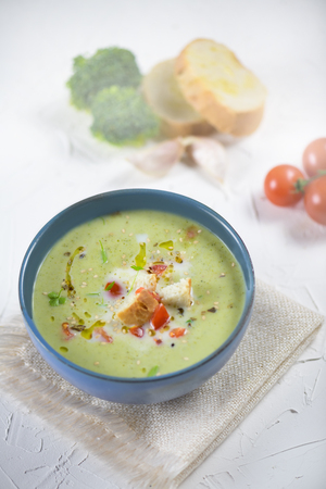 bowl of broccoli cream soup, croutons with olive oil, vegetarian soupの写真素材