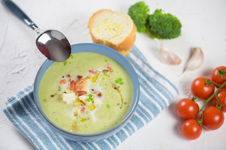 bowl of broccoli cream soup, croutons with olive oil, vegetarian soupの写真素材