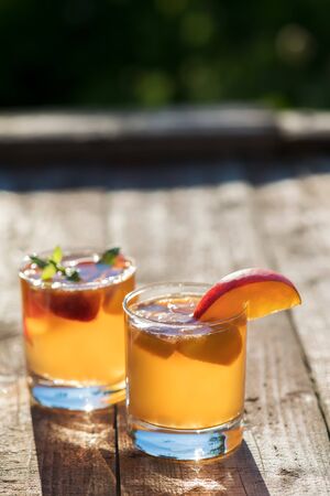Homemade Fermented Raw Kombucha Tea Ready to Drink With peach. Summer probiotic healthy beverage in glass.の写真素材