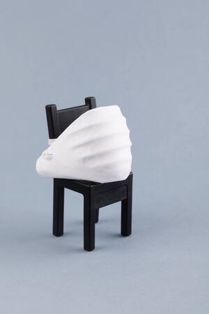 Coronavirus protection concept. One chair with medical face shield. Protect Yourself with mask from coronavirus while work. Stay alone and Avoid close contact, business and covid-19の写真素材