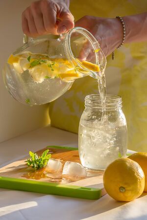 homemade lemonade with lemons, mint and ice on the tableの写真素材