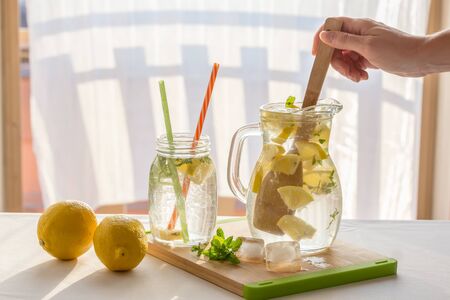 Homemade lemonade pitcher, preparation of lemonade, handの写真素材