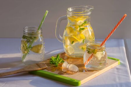 homemade lemonade with lemons, mint and ice on the tableの写真素材