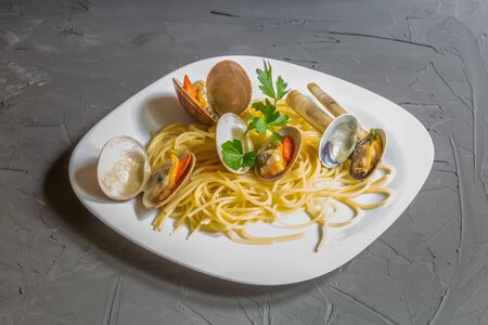 smooth clam with spaghetti on the grey background, italian cuisine, salento, apuliaの写真素材