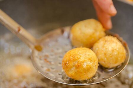 preparation of meatballs in a frying pan at homeの写真素材
