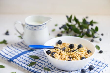 Healthy breakfast with blueberries and Oatmeal light wooden backgroundの写真素材