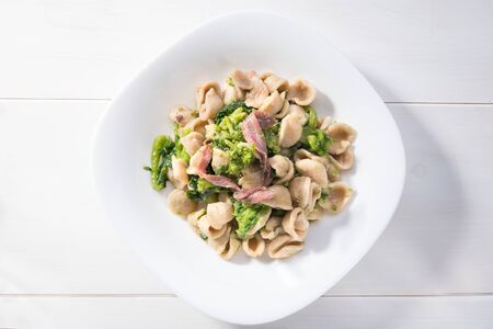 Homemade wholegrain Italian pasta, a traditional dish in Puglia, southern Italy, orecchiette with turnip greens and salted anchovies, served in Bari, top view with and close upの写真素材