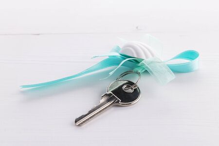 Home silver keys on wood. Real estate concept, property as a gift with copy space