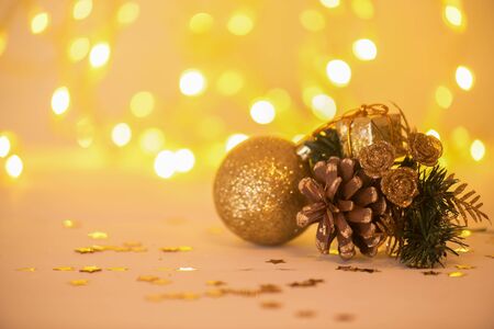Christmas card and decoration baubles with branches of fir tree on wooden board over light blurred...