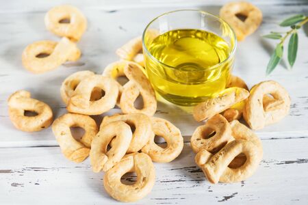 Taralli is a traditional Italian snack food typical of Puglia regional cuisine in wooden bowl. Ingredients: wine, olive oil, salt, flour of wheatの写真素材
