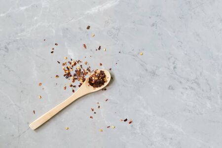 Spicy Chili paste mix with peppers on grey marble background. Peperoncino calabrese tritato. This condiment could be ingredient of harissa, ajika, muhammara or other middle east food. Copy spaceの写真素材